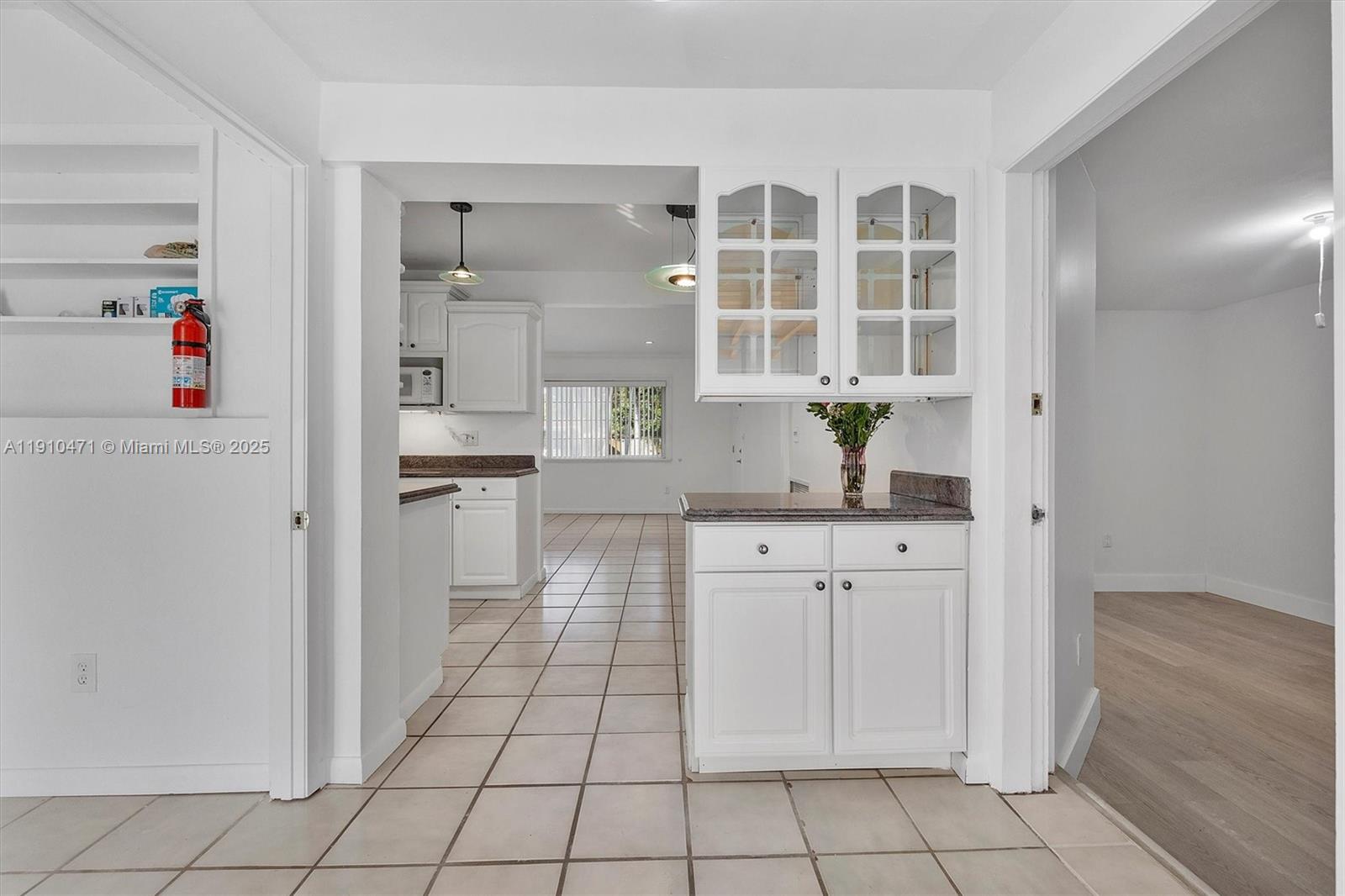 11111 Southwest 78th Court Pinecrest, FL 33156 - Photo 9 of 36 a kitchen with white cabinets and appliances