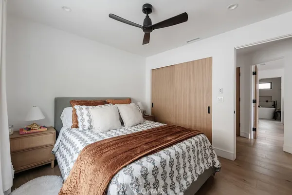 a bedroom with a bed and a flat screen tv