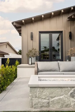 a balcony with furniture and a potted plant