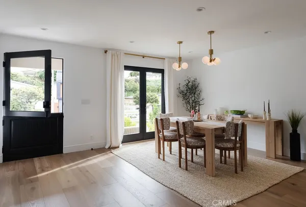 a view of a dining room with furniture window and wooden floor