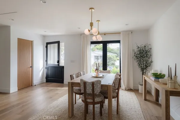 a kitchen with kitchen island a dining table chairs sink and cabinets