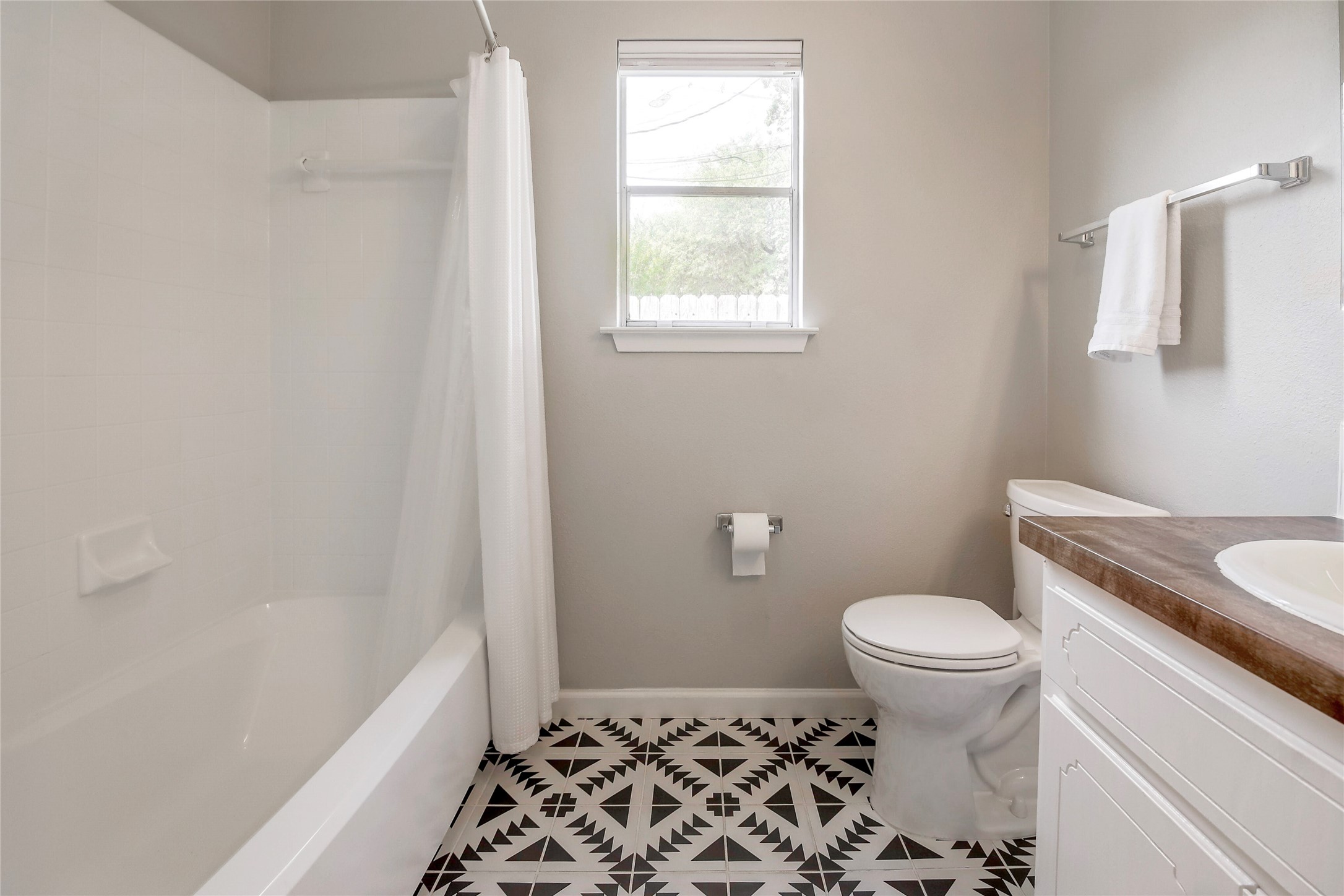 11118 Wandering Way Austin, TX 78754 - Photo 23 of 35 Primary bathroom has been updated to white surround shower
