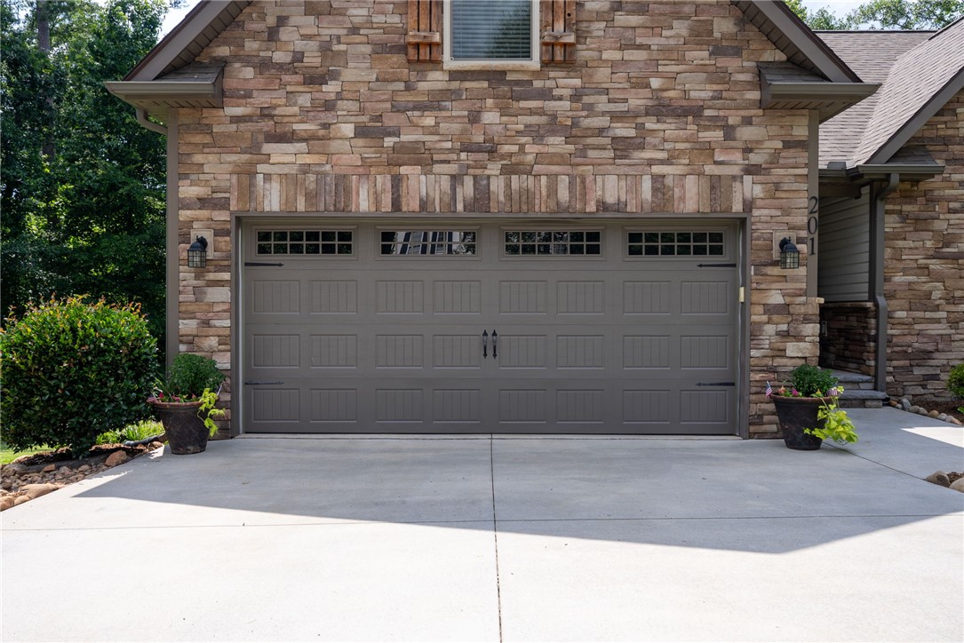201 Hearthstone Drive Anderson, SC 29621 - Photo 42 of 49 A stylish gray garage door complements the natural stone exterior of this charming residence.