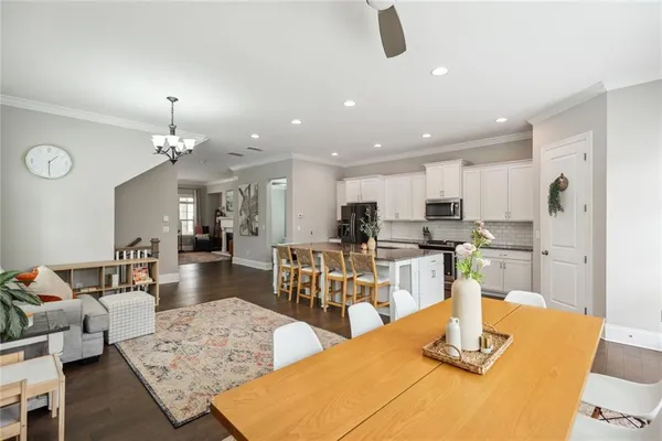 a living room with furniture a flat screen tv and a large window
