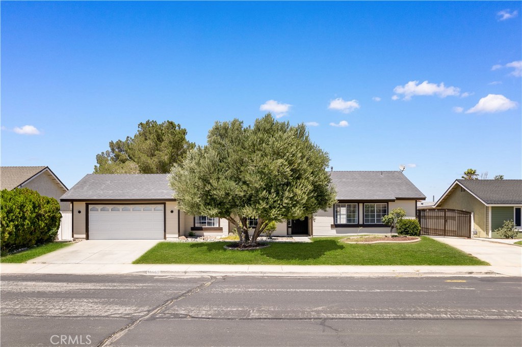 13466 Solitude Circle Victorville, CA 92392 - Photo 1 of 1 a front view of a house with a yard and garage