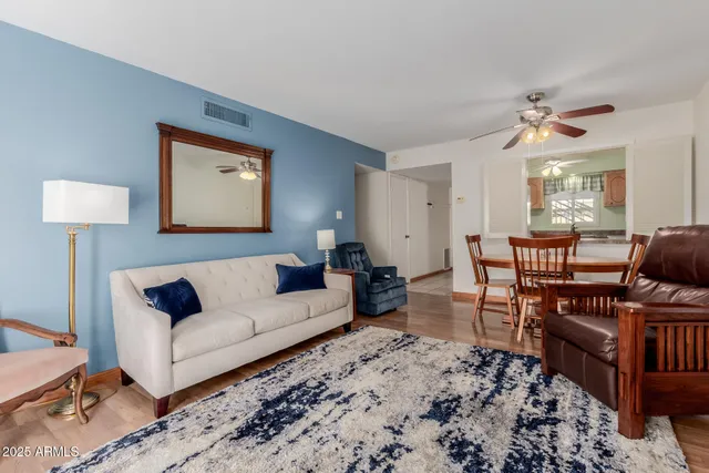 a living room with furniture a rug and a chandelier