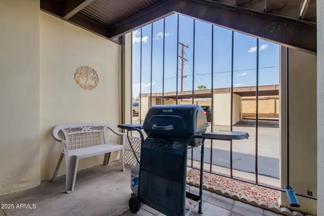 a view of balcony with a table and chairs