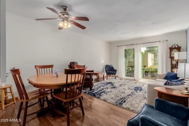 a view of a dining room with furniture a chandelier and wooden floor