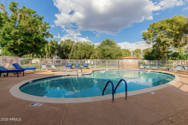 a view of a swimming pool with a lounge chairs