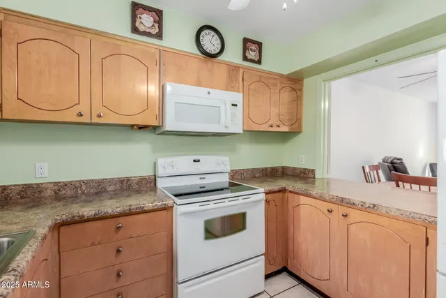 a kitchen with granite countertop cabinets stainless steel appliances and a sink