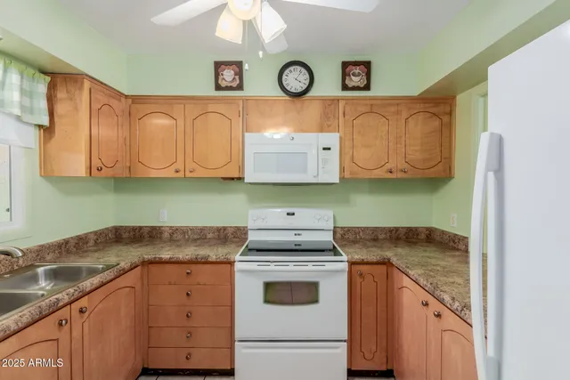 a kitchen with stainless steel appliances granite countertop a sink and a stove