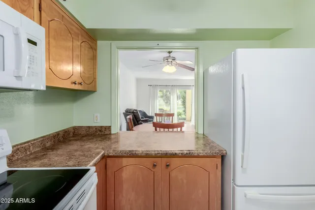 a kitchen with granite countertop cabinets stainless steel appliances and a sink