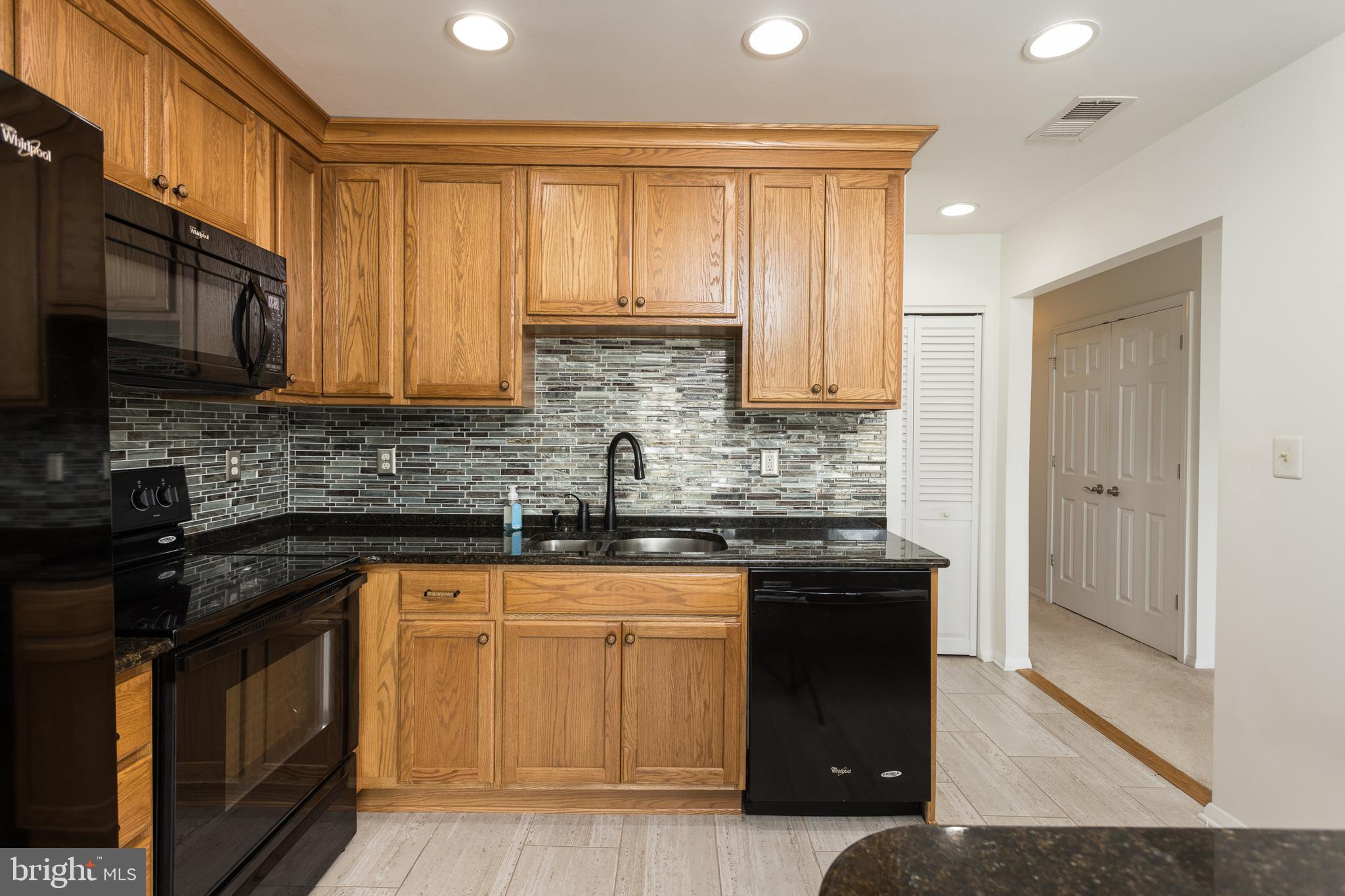 550 Riviera Drive, Unit 550B Joppa, MD 21085 - Photo 5 of 11 a kitchen with stainless steel appliances granite countertop a stove a sink and a microwave