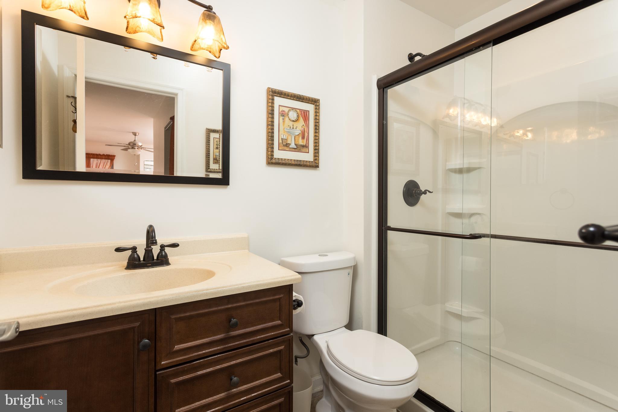 550 Riviera Drive, Unit 550B Joppa, MD 21085 - Photo 7 of 11 a bathroom with a sink a toilet a mirror and shower