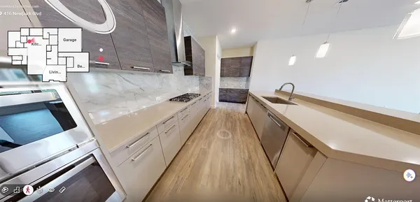 a view of a kitchen with a sink and wooden floor