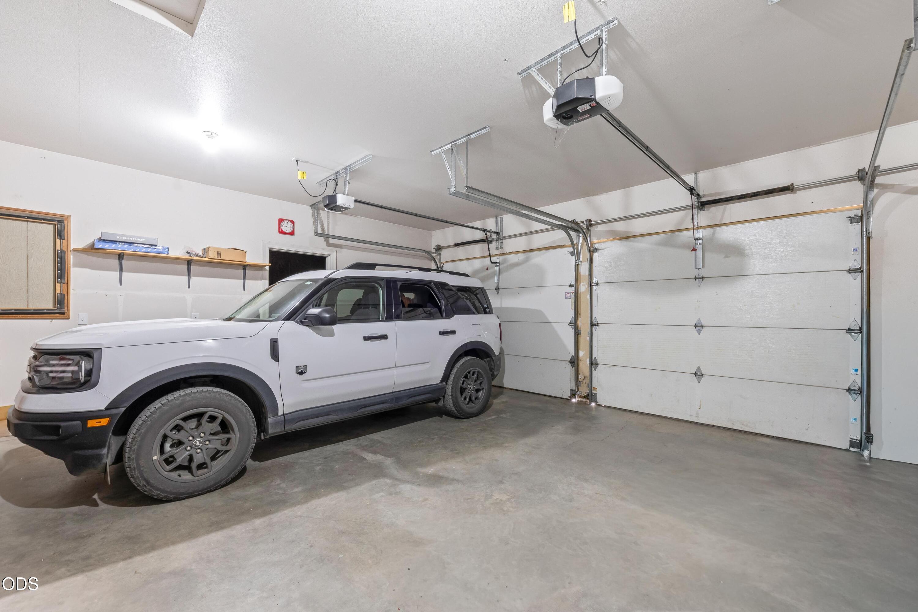 13753 South Sego Lily Road Powell Butte, OR 97753 - Photo 42 of 46 a view of a garage and car parked