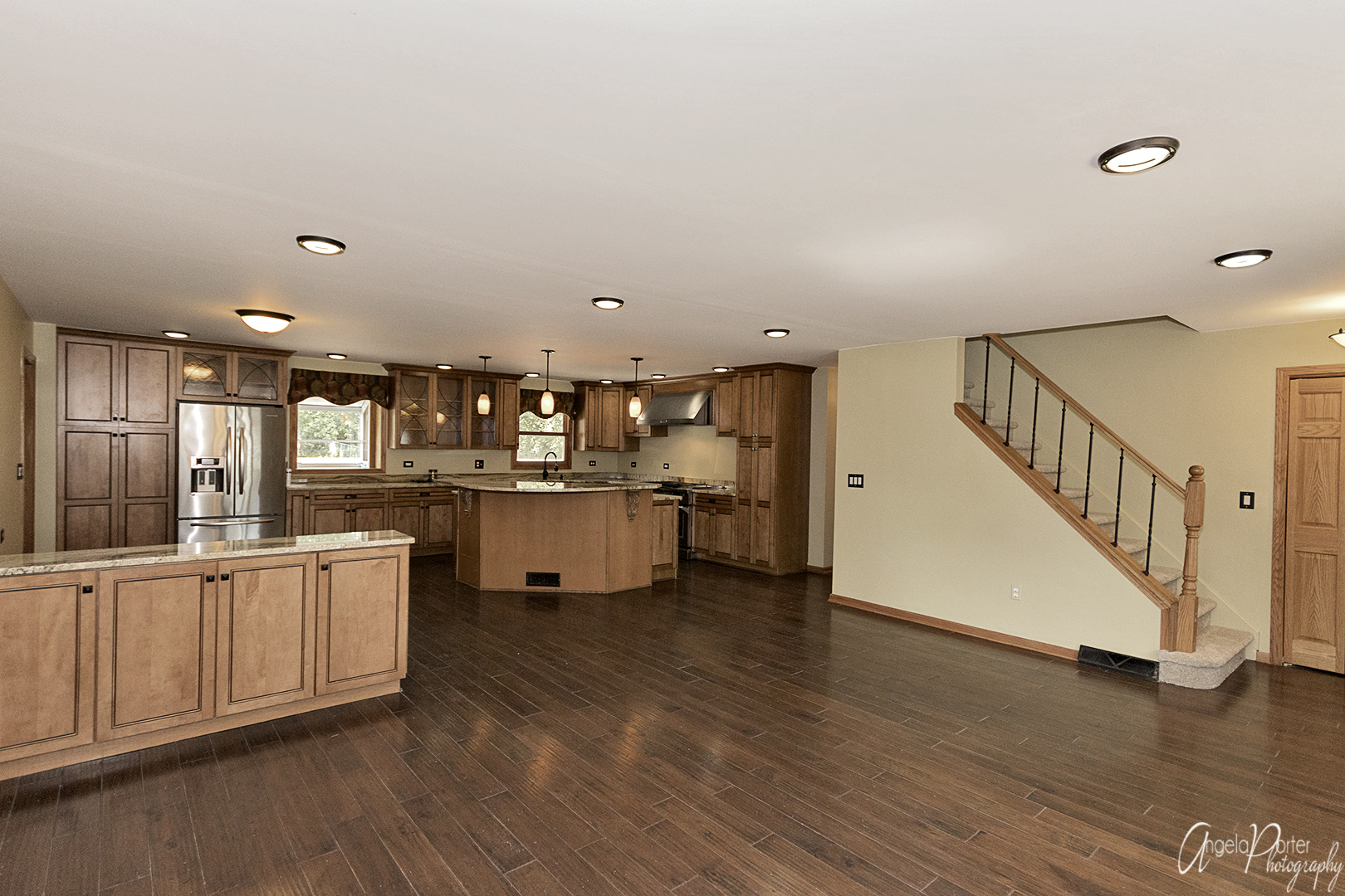39240 North Winchester Road Wadsworth, IL 60083 - Photo 3 of 28 a kitchen with stainless steel appliances kitchen island wooden floors and white cabinets