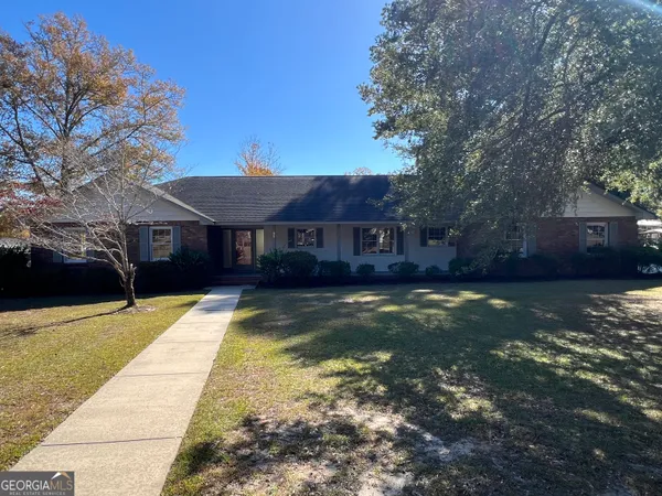 a view of house with yard swimming pool and a patio