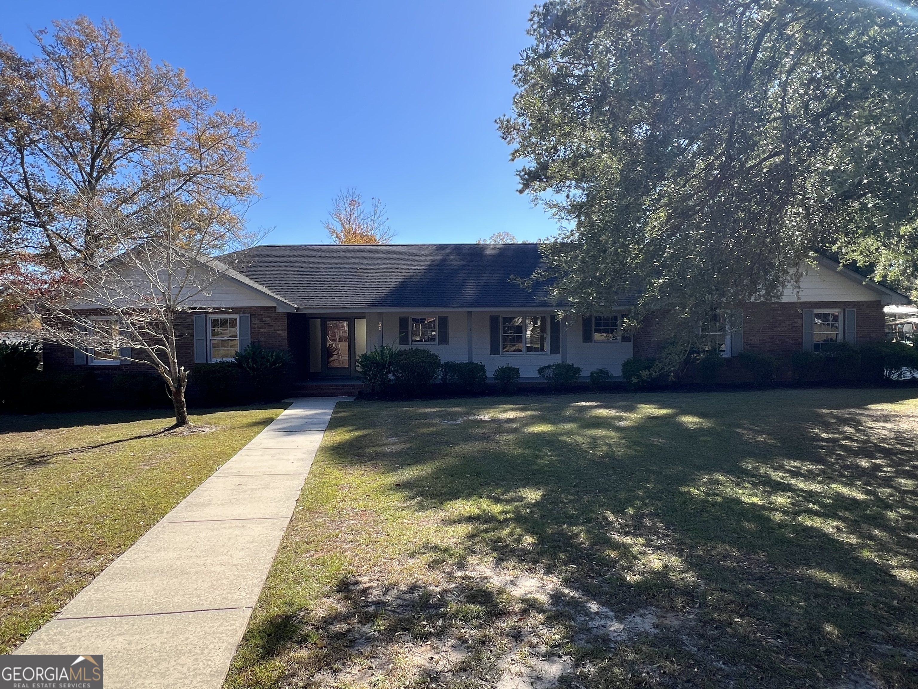 a view of house with yard swimming pool and a patio