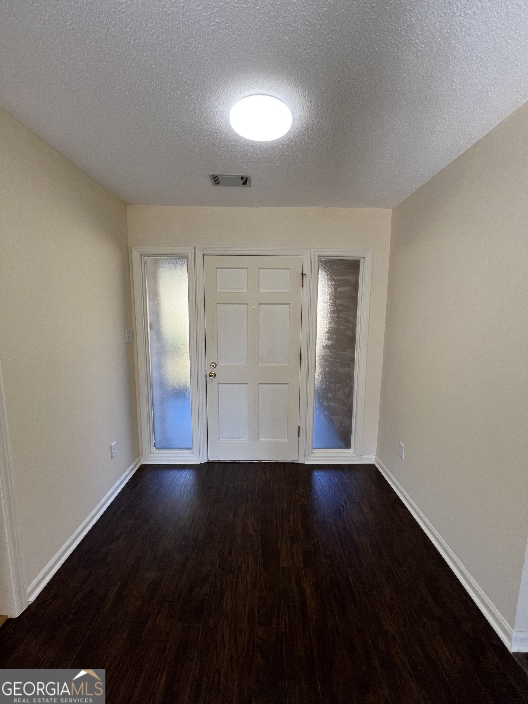 311 Fairmont Road Dublin, GA 31021 - Photo 23 of 33 a view of an empty room with wooden floor and a window