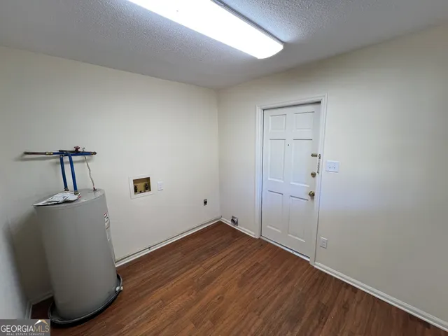 a view of a room with wooden floor and cabinet