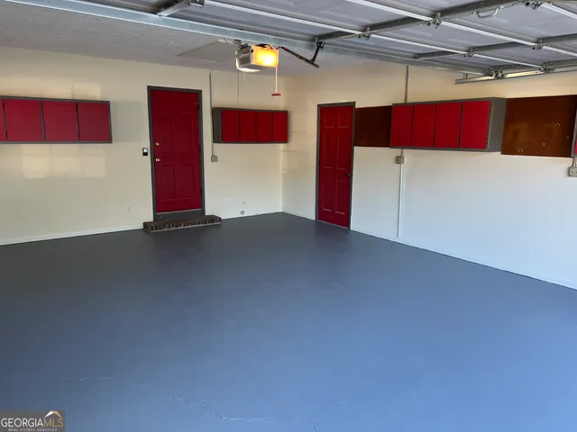 a view of a utility room with air conditioner duct and windows