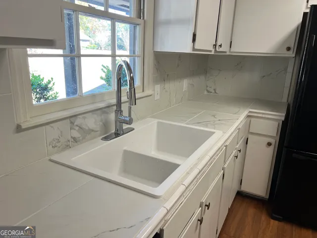 a kitchen with a sink and a window
