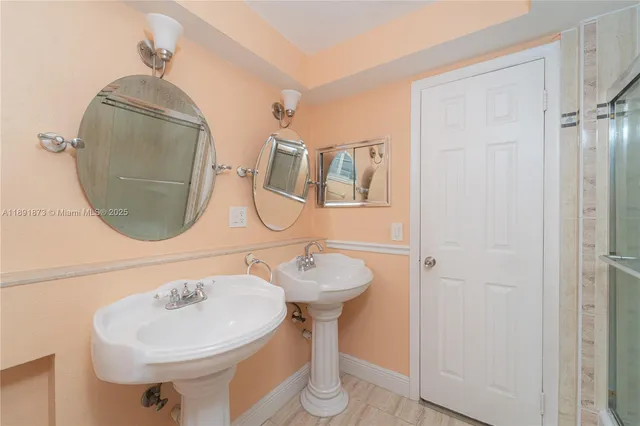 a bathroom with a sink toilet and a mirror
