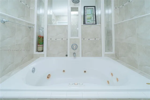 a bathroom with a tub and shower