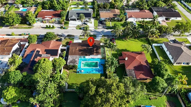 an aerial view of residential houses with outdoor space and lake view