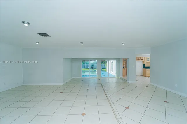 an empty room with windows and entrance