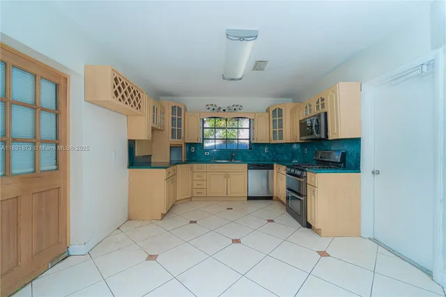a kitchen with granite countertop white cabinets and white appliances