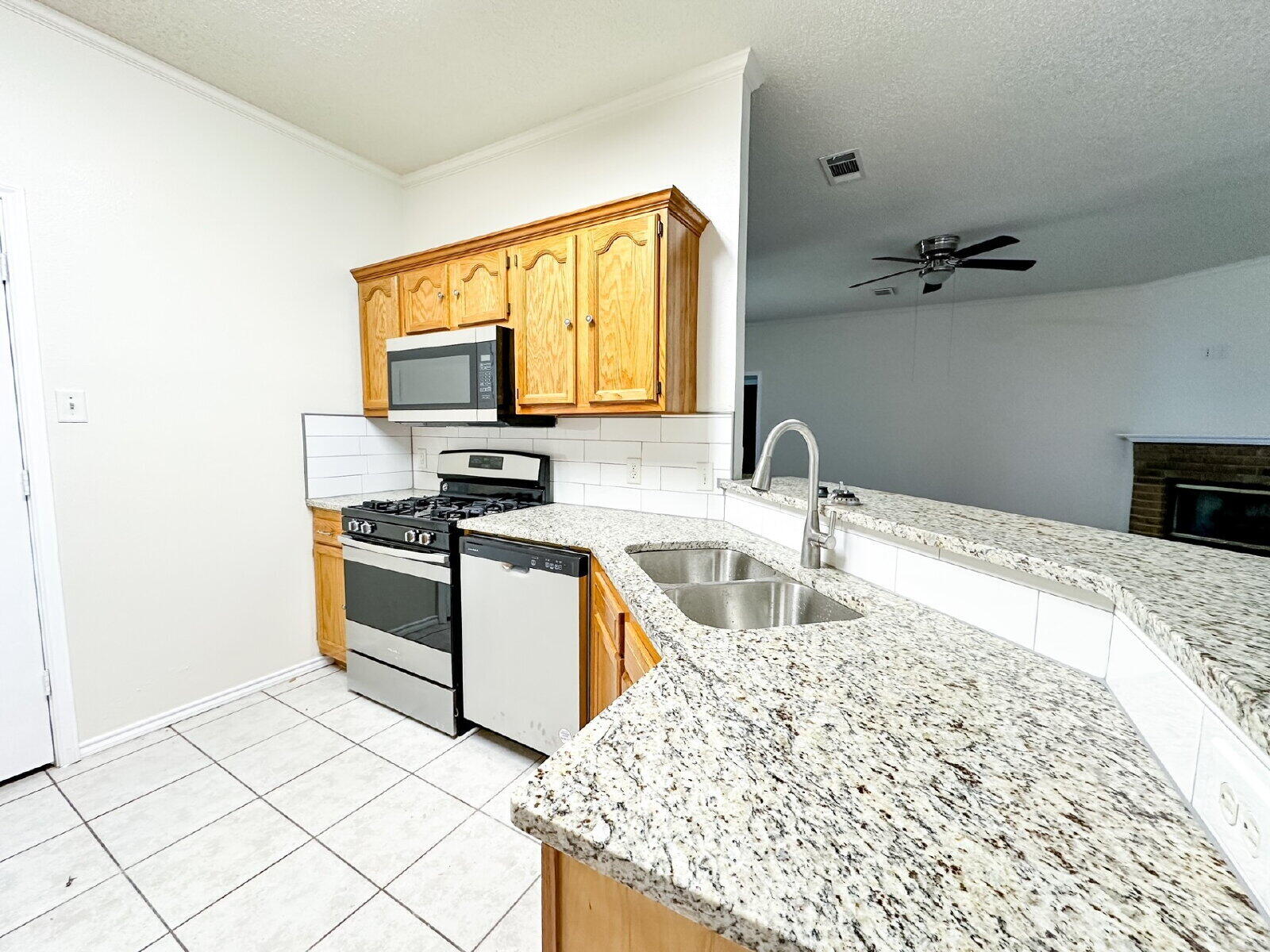 10622 Boston Avenue Lubbock, TX 79423 - Photo 11 of 28 a kitchen with granite countertop a sink and a stove top oven