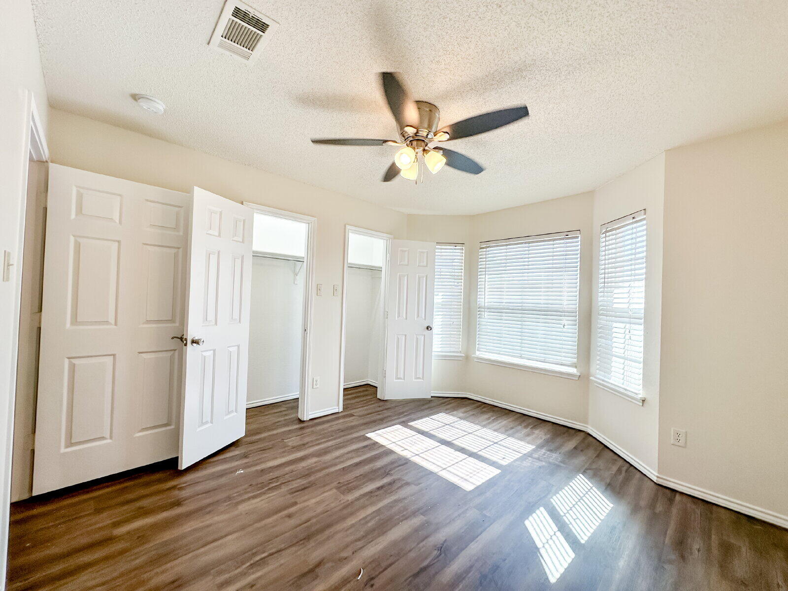 10622 Boston Avenue Lubbock, TX 79423 - Photo 19 of 28 a view of empty room with wooden floor and fan