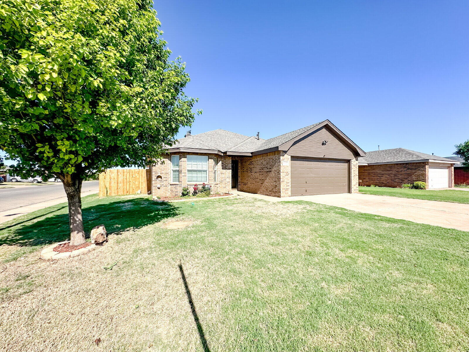 10622 Boston Avenue Lubbock, TX 79423 - Photo 2 of 28 a front view of a house with a yard and garage