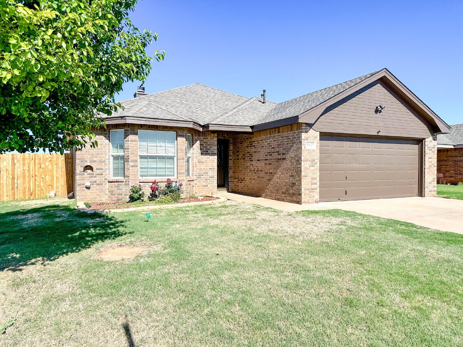 10622 Boston Avenue Lubbock, TX 79423 - Photo 24 of 28 a front view of a house with a yard and garage