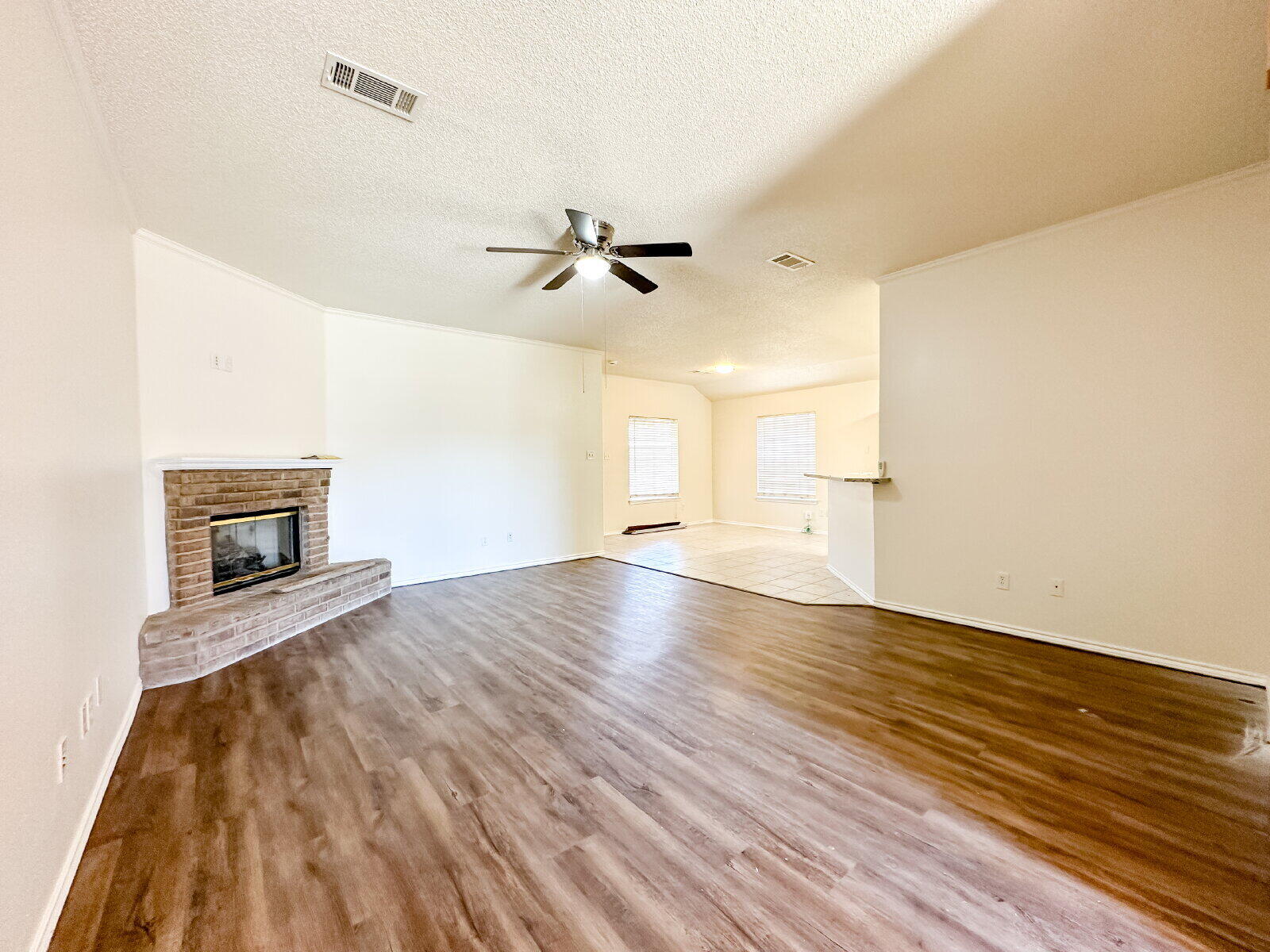 10622 Boston Avenue Lubbock, TX 79423 - Photo 4 of 28 a view of empty room with wooden floor and fan