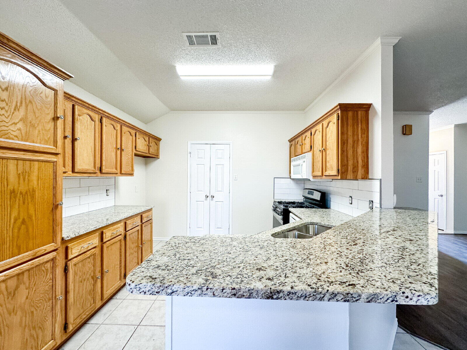 10622 Boston Avenue Lubbock, TX 79423 - Photo 10 of 28 a kitchen with sink and refrigerator