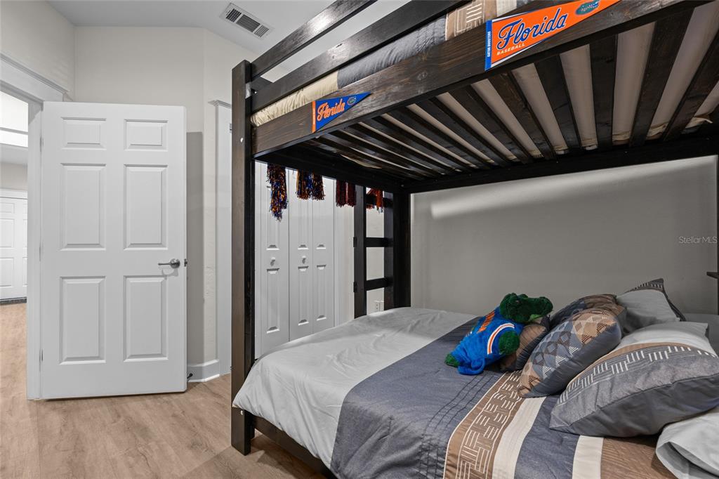 127 Northeast 3rd Street Gainesville, FL 32601 - Photo 15 of 30 a bedroom with bed and a walk in closet