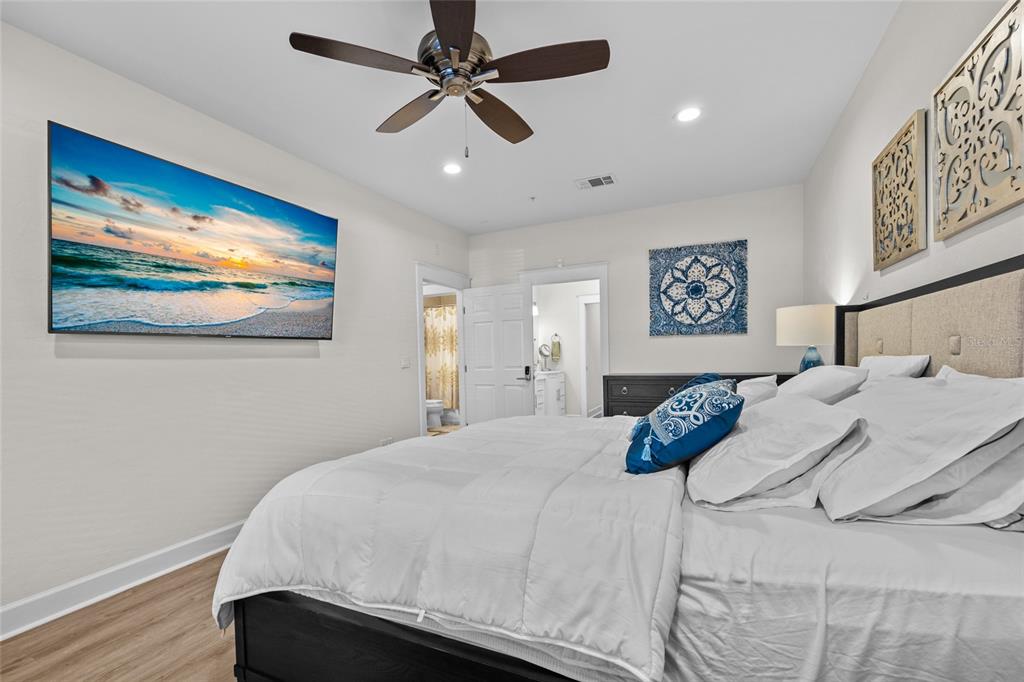 127 Northeast 3rd Street Gainesville, FL 32601 - Photo 18 of 30 a bedroom with a large bed and a painting on the wall
