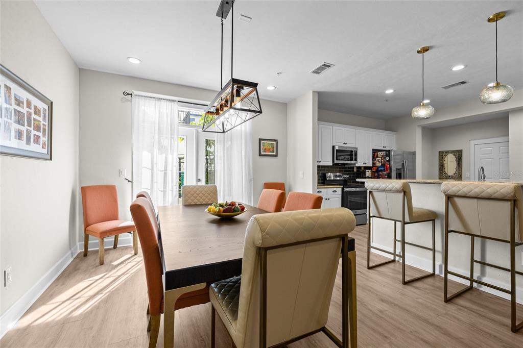 127 Northeast 3rd Street Gainesville, FL 32601 - Photo 9 of 30 a view of a dining room and livingroom with furniture wooden floor a chandelier