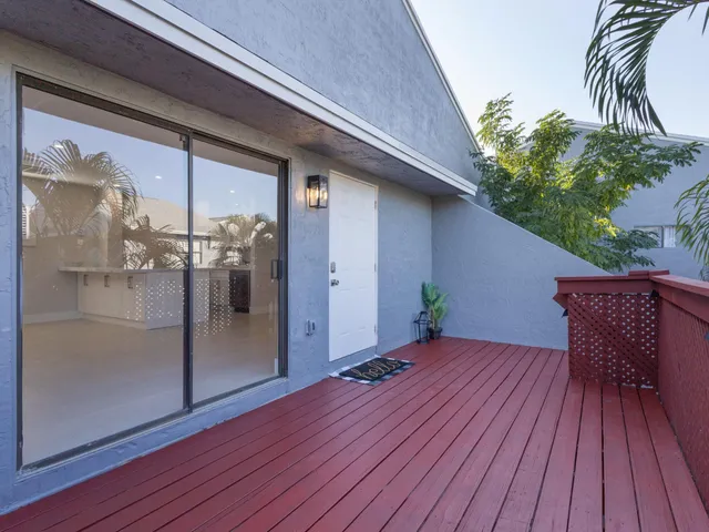a view of a kitchen with refrigerator and sink