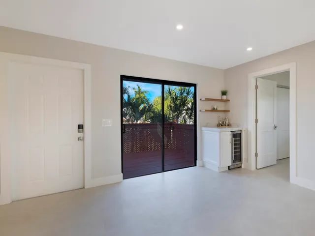 a kitchen with granite countertop a refrigerator and a sink