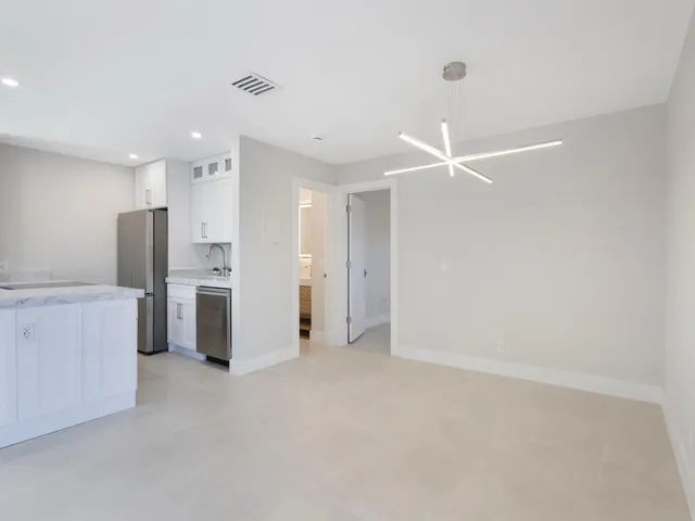 a kitchen with a refrigerator and a sink