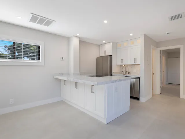 a view of kitchen with wooden floor and electronic appliances