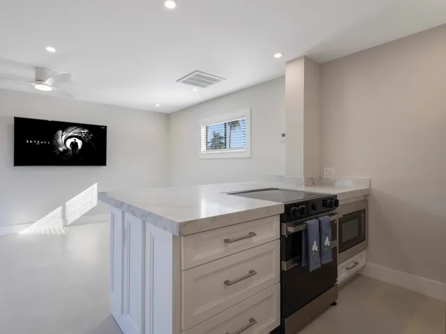 a view of a livingroom with furniture and a flat screen tv