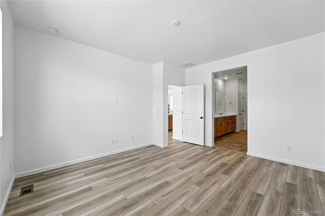 a view of a room with wooden floor
