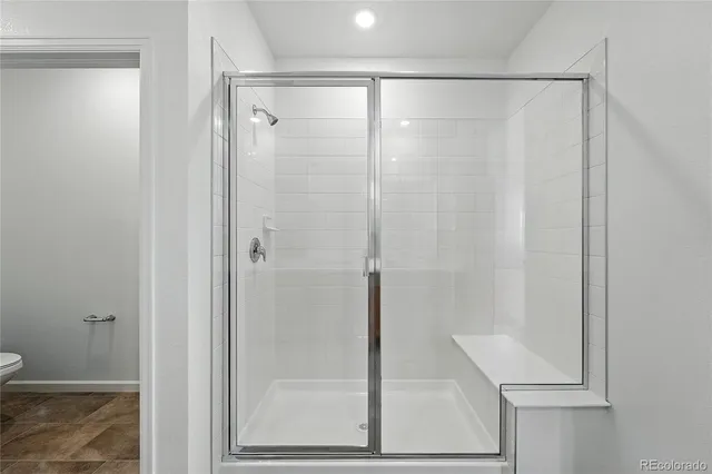 a bathroom with a glass shower door