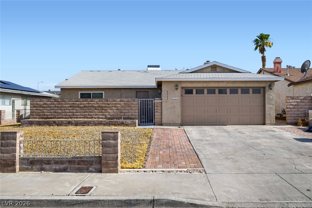 6321 Portola Road Las Vegas, NV 89108 - Photo 1 of 29 A classic ranch home presents with a driveway leading to an attached garage and a neatly maintained brick walkway.