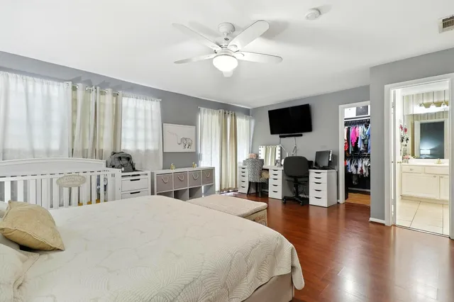 a bedroom with a bed window and a flat screen tv